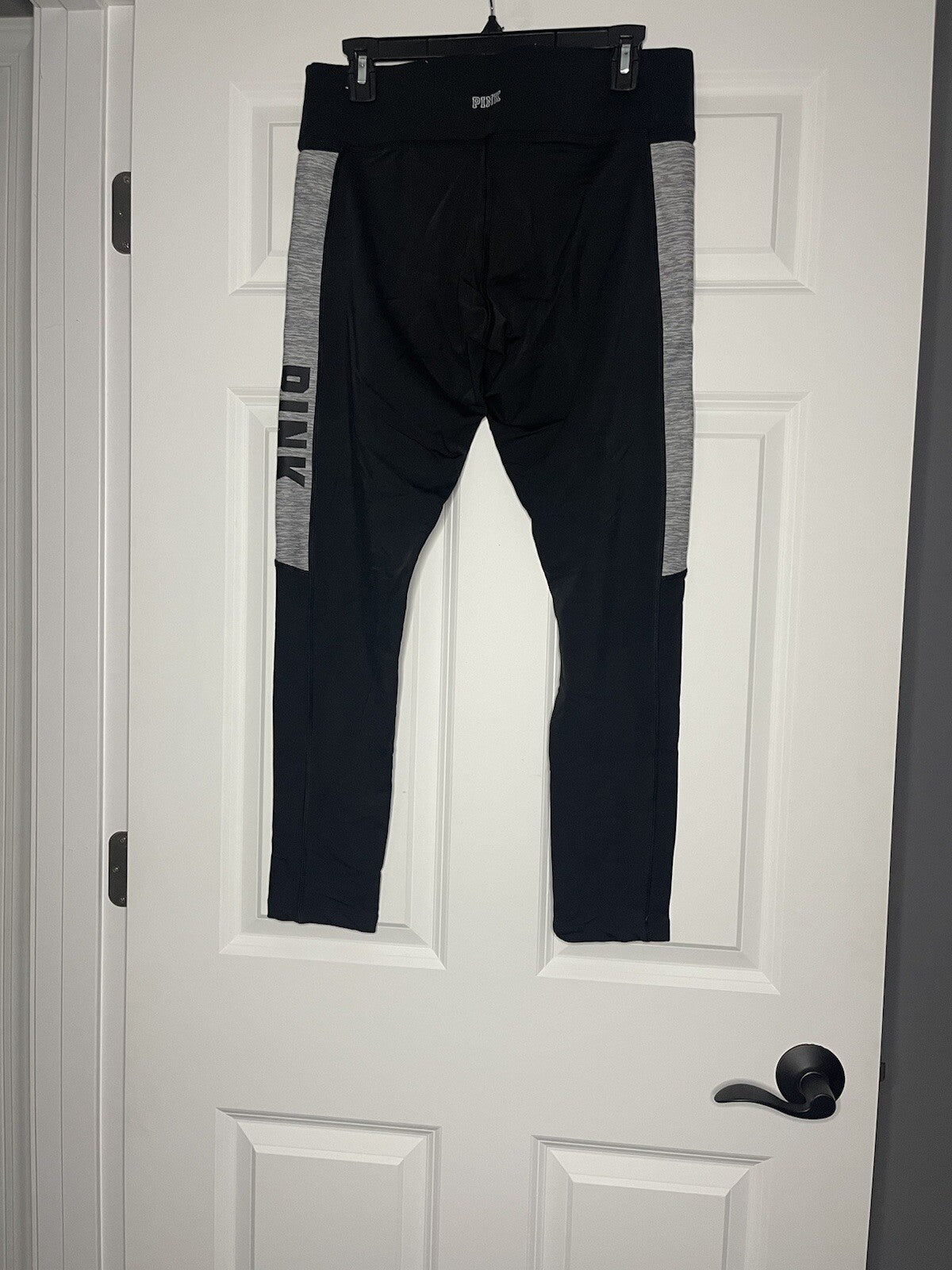 Pink ultimate leggings large cropped black with gray white logo on side