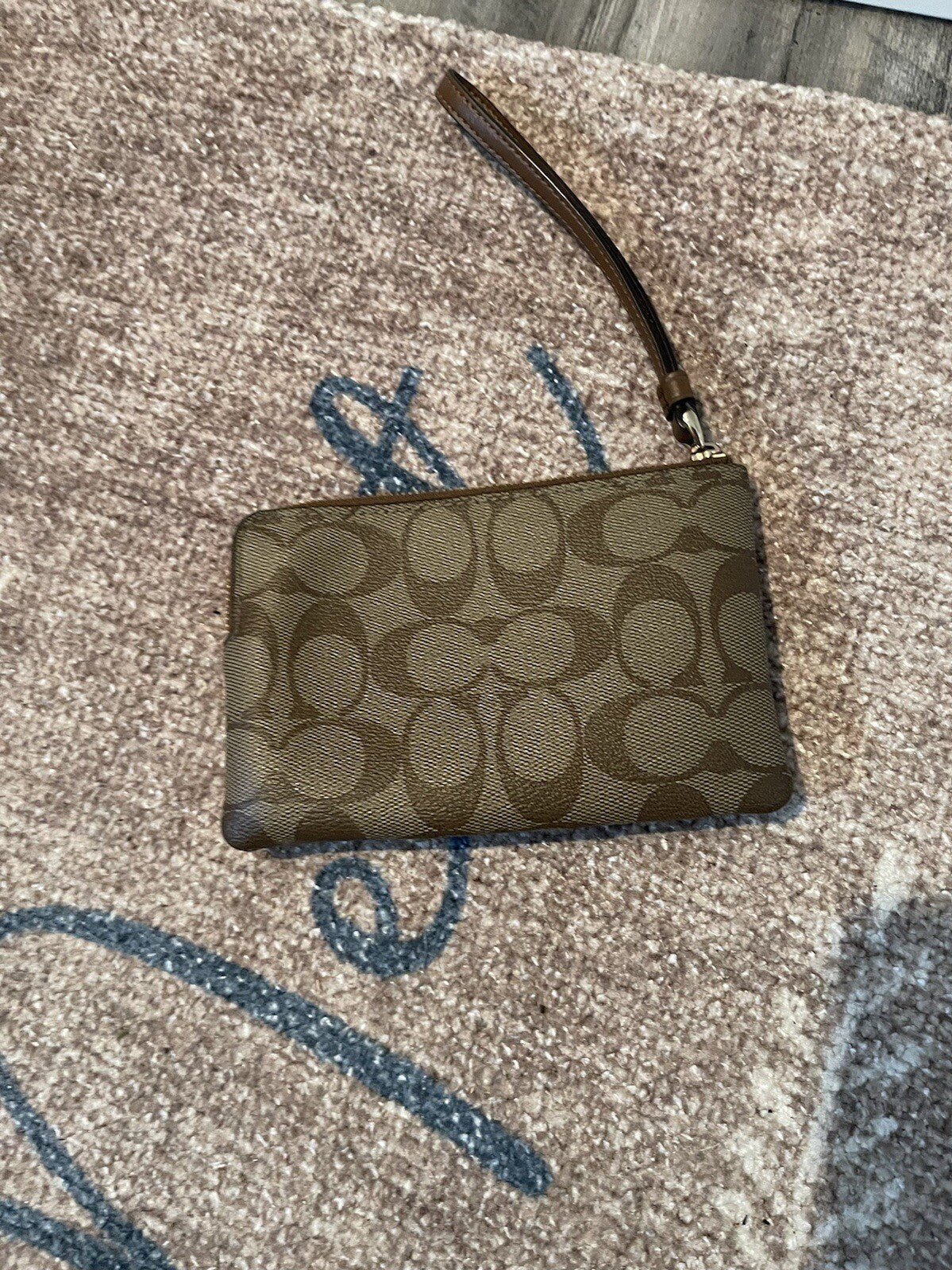 Coach wristlet small brown with logo in excellent condition 