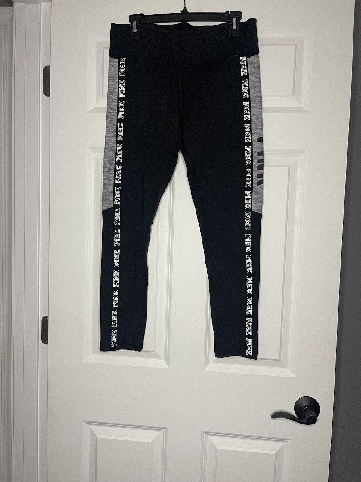 Pink ultimate leggings large cropped black with gray white logo on side 